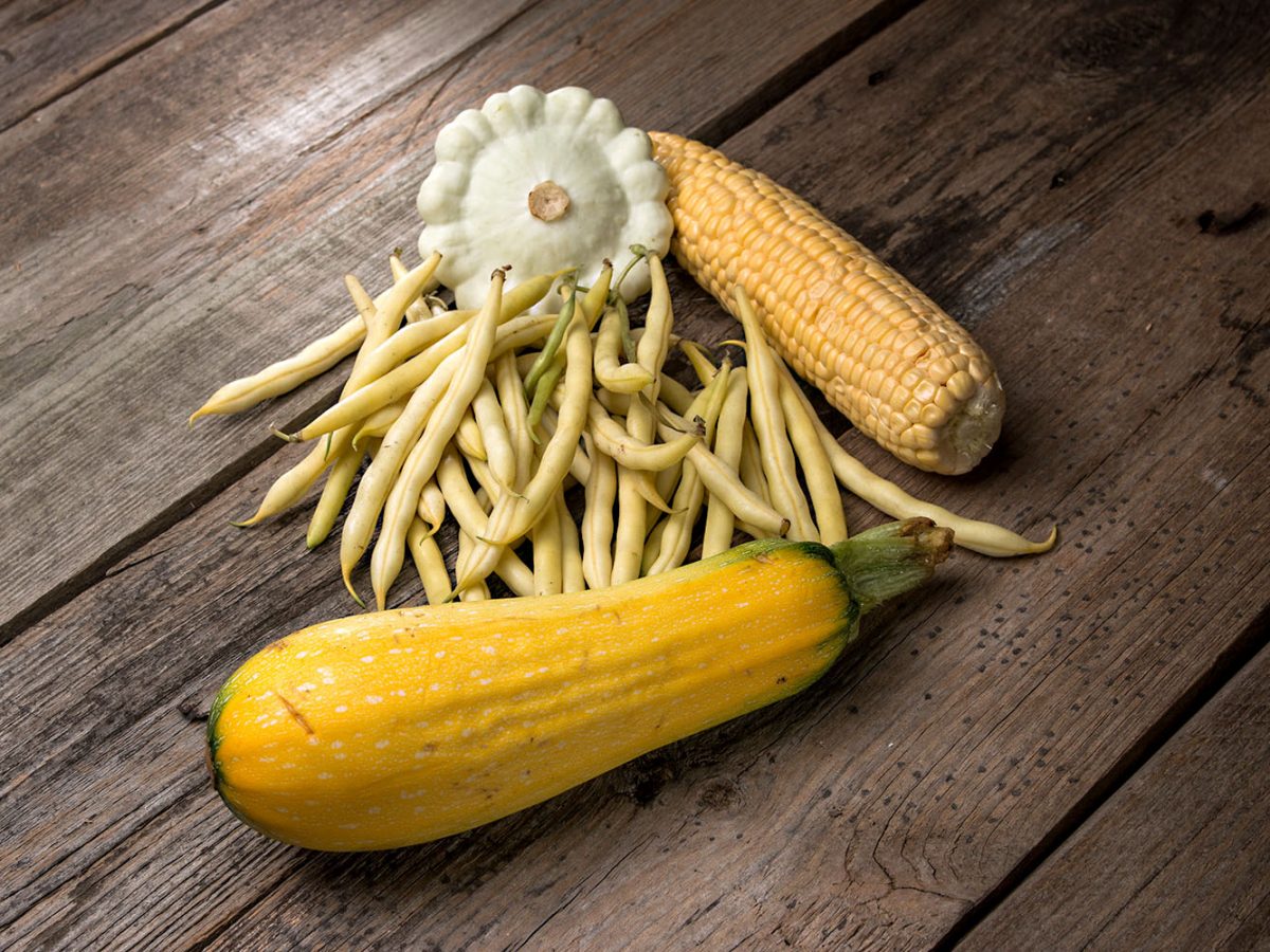 vegetables  green beans, corn, zucchini, squash on old wooden background in rustic style
