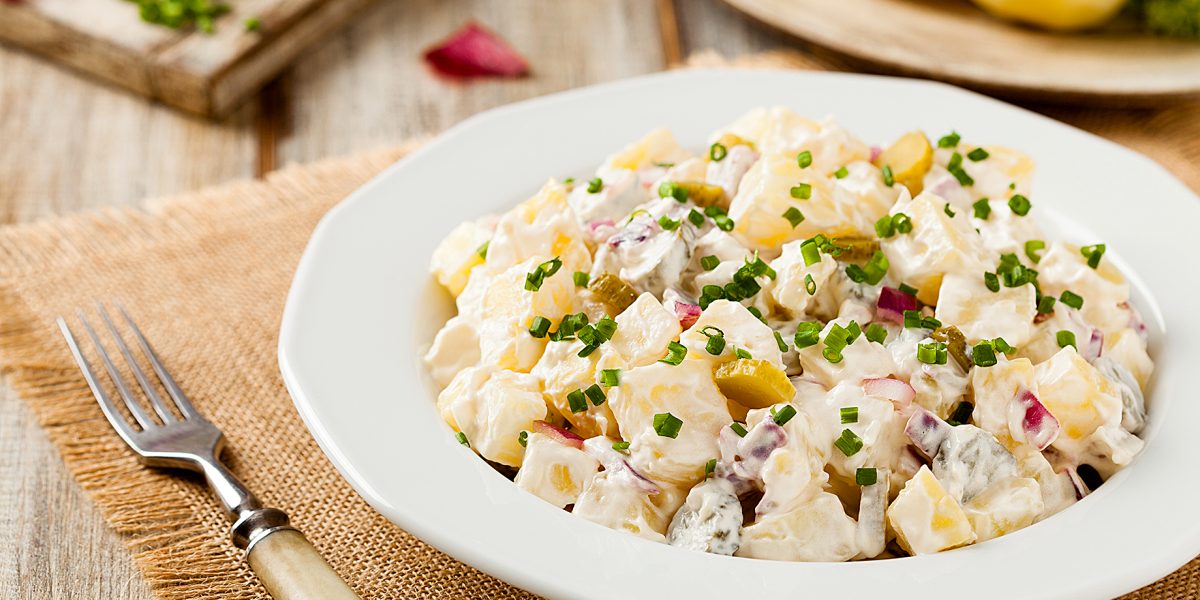 Traditional German potato salad with cucumber, onion and mayonnaise.