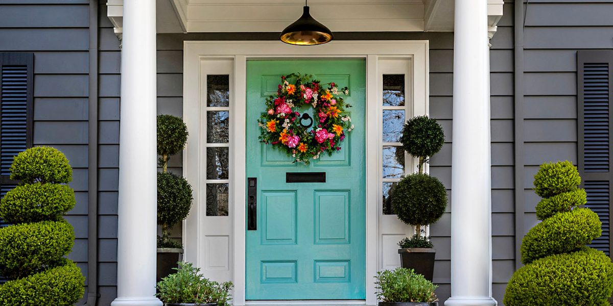 Beautifully,Decorated,Front,Door,Of,Traditional,Home.,Brick,Path,And Beautifully decorated front door of traditional home. Brick path and trimmed hedges.
