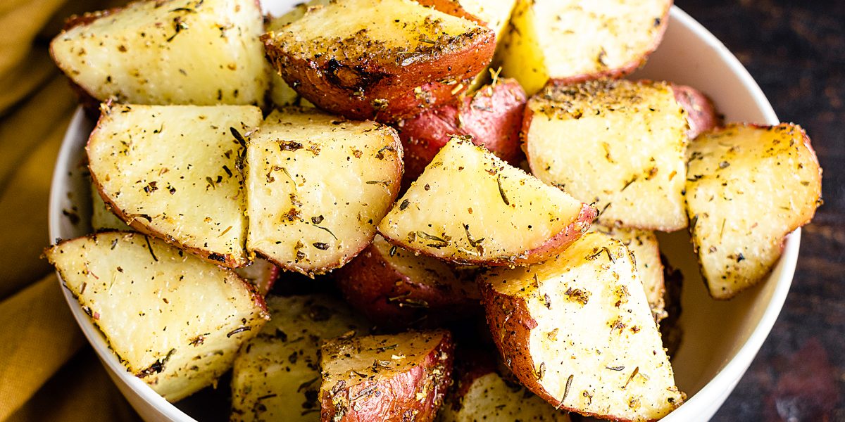 Tuscan Roasted Red Potatoes in a Serving Bowl: Roasted red potatoes coated in olive oil, spices, and garlic